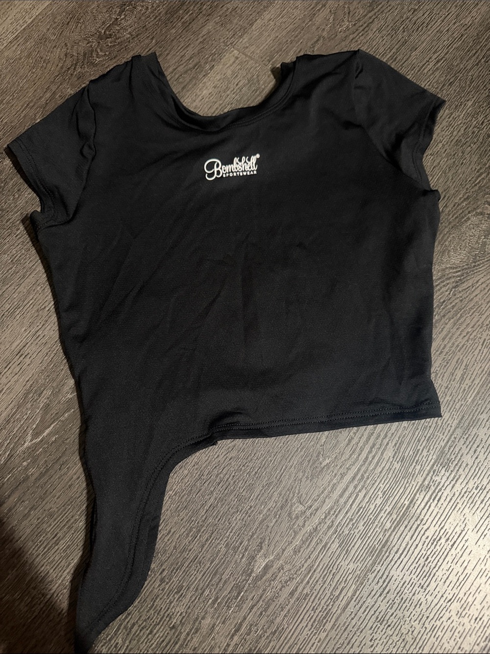 Bombshell Sportswear Black Asymmetric Crop Top with White Logo